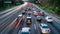 Cars stuck in traffic at night on motorway with many lanes