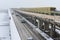 Cars and a subway train move across the Metro bridge