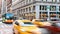 Cars, taxis and buses speed through the busy intersection of 23rd Street and 5th Avenue in New York City