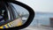 Cars traffic along road view in left side mirror of auto