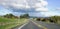 Cars travelling along a rural road in New Zealand.