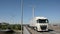 Cars and trucks passing over a bridge in the harbor of Ghent