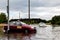 Cars trying to drive against flood on the street in Gdansk, Poland.