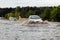 Cars trying to drive against flood on the street in Gdansk, Poland.