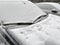 cars under snow on a parking in snowfall and blizzard. First snow, closeup