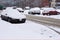 Cars under the snow in a street