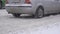 Cars and vehicles ride on a snowy road in the city, reagents clearing the road in winter, background, slow motion, close
