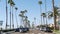 Cars on waterfront road. Pacific ocean tropical beach, palm trees. Beachfront street, California USA