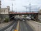 Cars weaving through the architectural arteries beneath the bridge