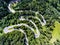 Cars on winding road trough the forest aerial view