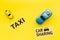 Carsharing vs taxi concept. Comparing carsharing system and taxi. Ship trip concept. Toy cars and text signs on yellow