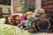 a cart with flowers and a bench entrance to the house.