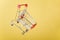 Cart, hand-cart, shopping cart, trolley on a yellow background. concept buyer,Shopper