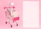 Cart with tweezers on pink background copy space