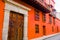 CARTAGENA, COLOMBIA 22, 2017: Cartagena city street with orange building and gorgeous wooden huge door of Cartagena