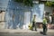 Cartagena, Colombia - March 26 2017: Police officers in reflective vests walking down a street in Cartagena with a blue aluminum c