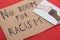 Carton placard with say no room for racism lettering and picture with drawn multiethnic hands doing fist bump