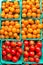 Cartons of orange and red variety of ripe cherry tomatoes