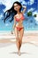 Cartoon beautiful brunette girl in swimsuit on a tropical seashore