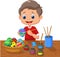 Cartoon boy painting Easter eggs