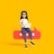 Cartoon funny smiling cute active girl in a white t-shirt and jeans with a laptop sits on a talking bubble on a yellow background