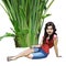 Cartoon girl sits under a green tropical plant