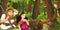 Cartoon scene with older man farmer or hunter talking to some princess in the forest encountering pair of owls flying -