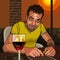 Cartoon smiling man sitting at a table with a glass of wine