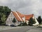 Cartoon style picture of a traditional German house Fachwerk with red tile roof and white walls.