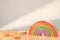 Cartoon styled rainbow on wooden table