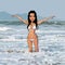 Cartoon woman in white swimsuit standing in the sea