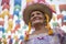 Caruaru, Pernambuco, Brazil - July 11, 2016: Woman with traditional clothing under colorful pennants during the celebration of Bra