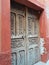 Carved Antique Wooden Door and Rustic Mexican Stucco Doorway with Brown and Rust Textured Wall Background