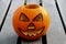 Carved Halloween Pumpkin on a Frosty Picnic Bench