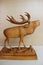 Carved image of European deer on a wooden base