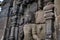 Carved image of a person on the facade of a building of an ancient Hindu stone temple