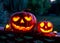 Carved pumpkins for Halloween jack-o\\\'-lanterns with scary smiles to ward of evil spirits on mystery forest background
