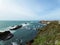 Carved Rocks off the Shore with a Lighthouse - Road Trip Down Highway 1 Discovery Route