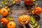 Carved smiling halloween pumpkin head among pumpkins on wooden background top view copyspace