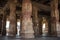 Carved stone columns in an ancient temple. The ruin of ancient temples near the village of Hampi. Krishna Temple. India