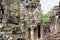 Carved stone face of ancient buddhist temple Bayon in Angkor Wat complex, Cambodia. Cambodian place of interest