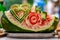 Carved watermelon floral decoration with heart and letters. The art of fruits and vegetable carving. Sculpture fruits and