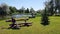 Carved wood figure sitting on a bench by a pond in the Latvian village of Kabile on June 13, 2020