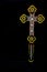 Carved wooden Crucifix on plain black background.