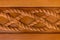 Carved wooden pattern on a horizontal board