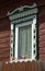 Carved wooden platband on window of old wooden house, Kostroma, Russia