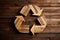 Carved wooden recycling logo on sustainable wood background, generative AI