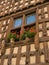 Carved wooden window with fleur-de-lis. Arreau. France