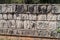 Carveed skulls at the Platform of Sculls at the archeological site Chichen Itza, Mexi