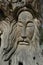 carving on an old olive tree in the Park of the resort of Matala, Greece, Crete